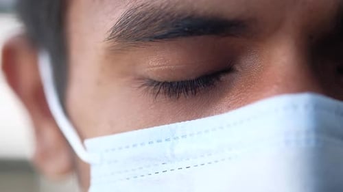 Close Up of Man with Protective Face Mask Looking at Camera