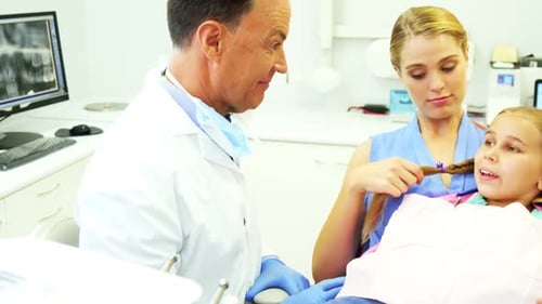 Dentist interacting with young patient
