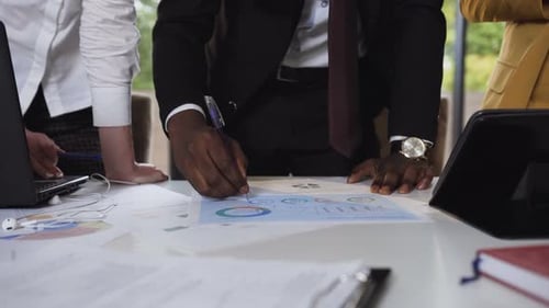 Business Professionals Reviewing Charts in Modern Workplace