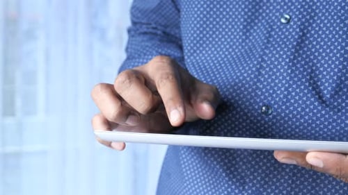 Close Up of Man Hand Working on Digital Tablet