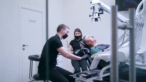 Dentist with Assistant Doing Surgery