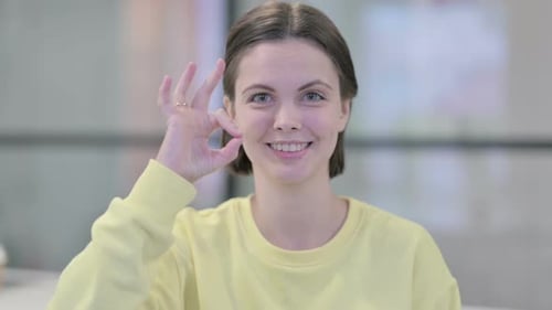 Young Woman Gives OK Hand Gesture