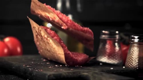 The Super Slow Motion of the Raw Burger Falls on the Cutting Board