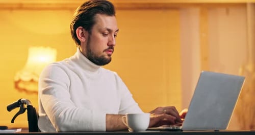 Handicaped Businessman Working on Laptop Computer at Home Office Male Professional Typing on Laptop