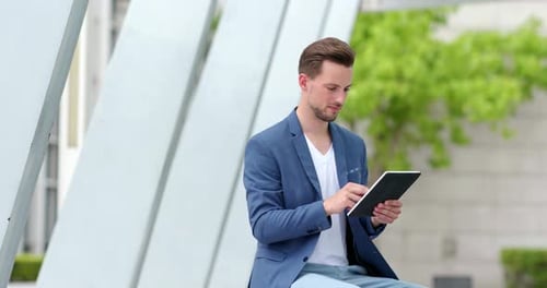 Young Adult Using Tablet in Urban Setting