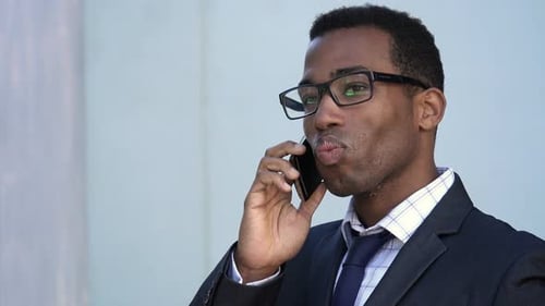 Businessman in Suit Talking on Smartphone