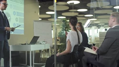 Man Giving Business Presentation to Colleagues in Office