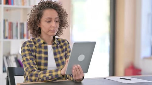 Woman Using Tablet at Desk Indoors