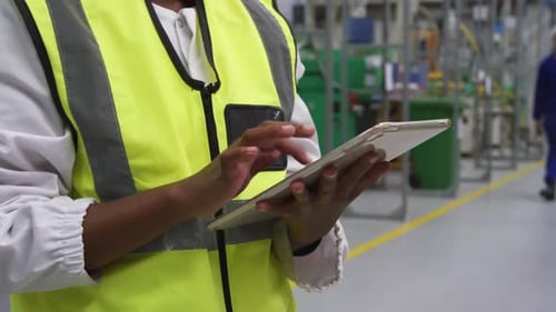 Warehouse female worker using digital tablet