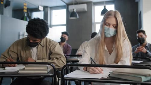 Students Writing with Face Masks in Classroom