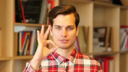 Young Man Gives OK Hand Gesture