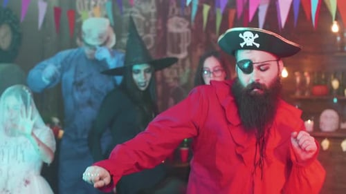 People in Costumes Dance at Halloween Party