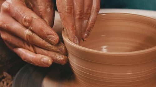 Hands Forming Clay on Potter's Wheel