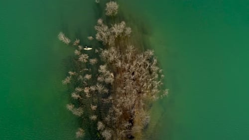 Aerial view of a person kayaking on Plastiras lake in Greece.