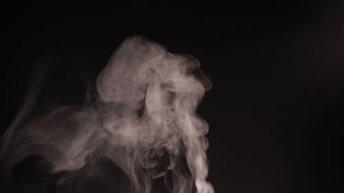 White Smoke Rising and Drifting on Black Background
