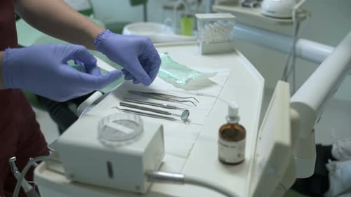Hands arranging tools in a dental clinic
