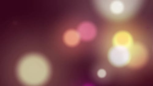 Animation von bunten leuchtenden Lichtpunkten, die sich in hypnotischer Bewegung auf dem Hintergrund bewegen