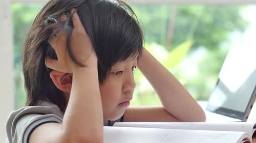 Frustrated Child Doing Homework at Desk