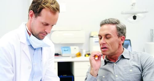 Patient Describes Toothache to Doctor in Clinic