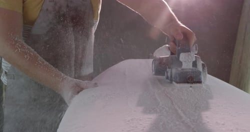 Male surfboard maker in his workshop