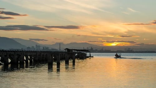 Timelapse sunrise disrepair fishing dock