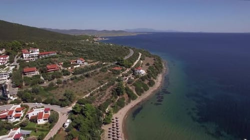 Flying Over Sea, Cottages and Resort on the Coast. Trikorfo Beach, Greece