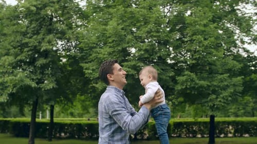 Loving Father and Baby Playing in Park
