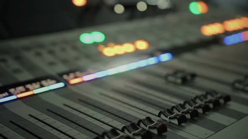 Lighting Buttons, Adjusting Knobs and Faders on Expensive Audio Mixing Console