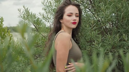 Pretty Woman Touching Hair on Beach