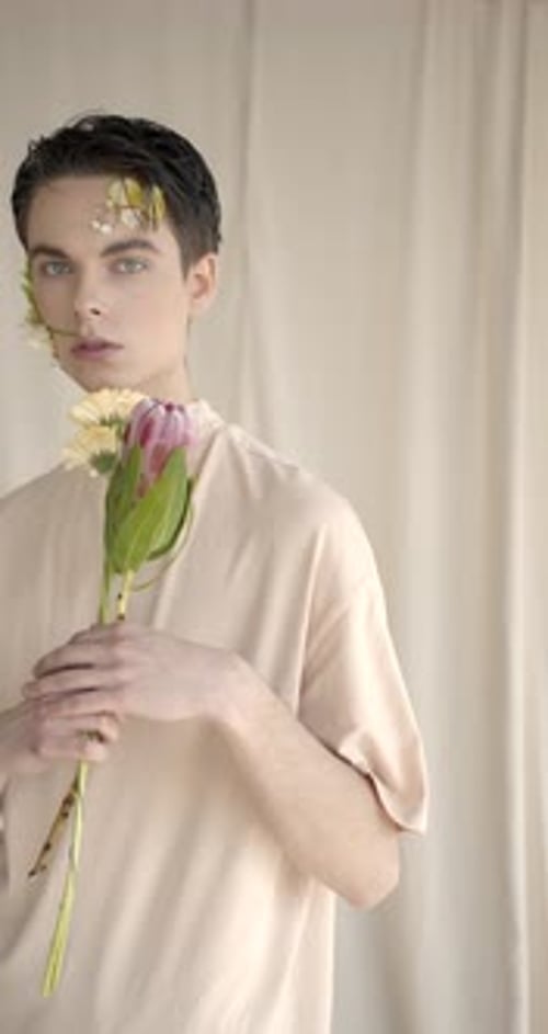 Stylish Young Adult Holding Flowers in Studio