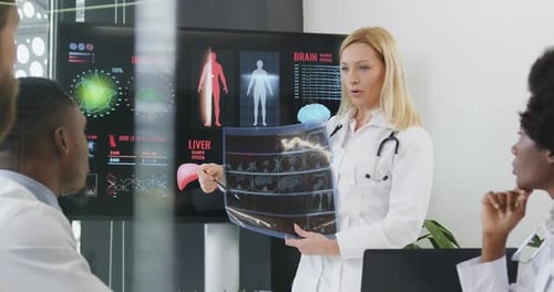 Medical Professionals Analyze X-Ray in Modern Office