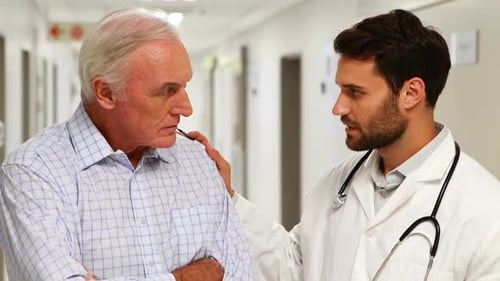 Doctor Comforts Worried Patient in Hospital Hallway