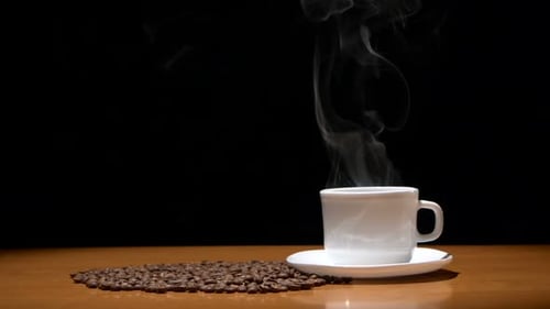 Steaming Coffee Cup with Coffee Beans on Table