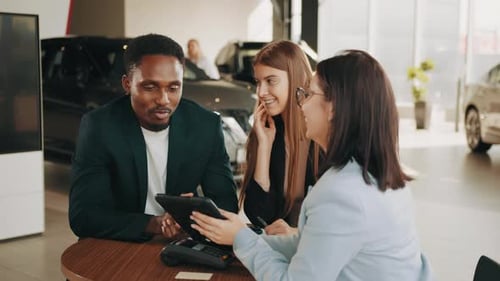 Car Saleswoman Meeting with Couple at Dealership