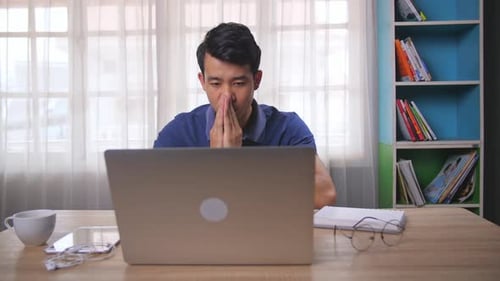 Serious Asian Man Working With Computer
