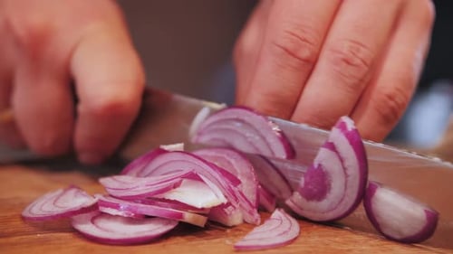 Slicing a Red Onion on a Cutting Board