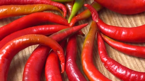 Bright Red Chili Peppers Arranged on Wood Surface