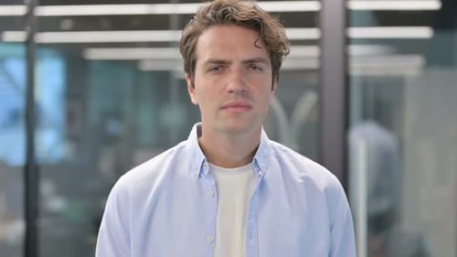 Surprised Man Covering Mouth in Office Setting