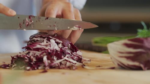 Close up shot of man cutting cabbage