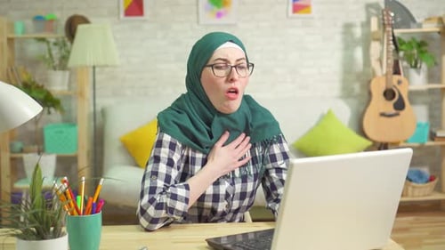 Woman Using Laptop Experiences Breathing Difficulty, Uses Inhaler