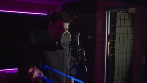 Emotional Cool Black Hip Hop Artist Rapping New Track Into Microphone in Sound Recording Studio