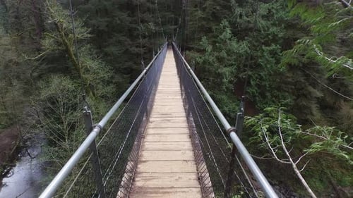 POV shot, walking across suspension bridge