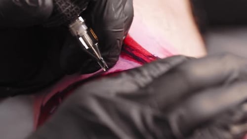 Tattoo Session Tattooing the Letters Over Red Sketch on the Skin