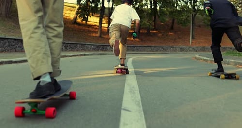 The Boy's Company Skates Through the Eternal Dark City. Longboarding at Sunset.