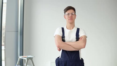 Young Master in Work Uniform and Protective Glasses Looking at the Camera