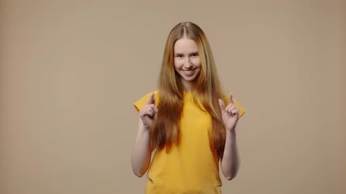 Woman Smiles and Makes Affectionate Hand Gestures