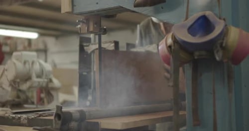 Machine Cutting Wood in Workshop