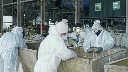 Workers Sorting Waste at Garbage Recycling Factory