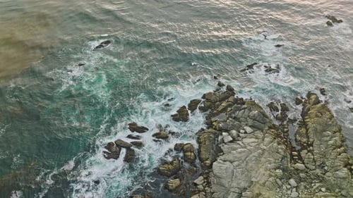 Rugged cliffs and colorful ocean in Pacific Coast of California