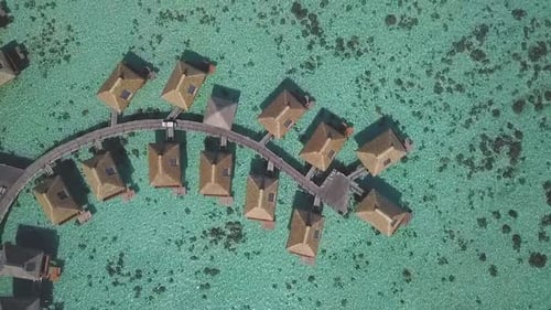 Aerial View of Island Resort Over Turquoise Ocean